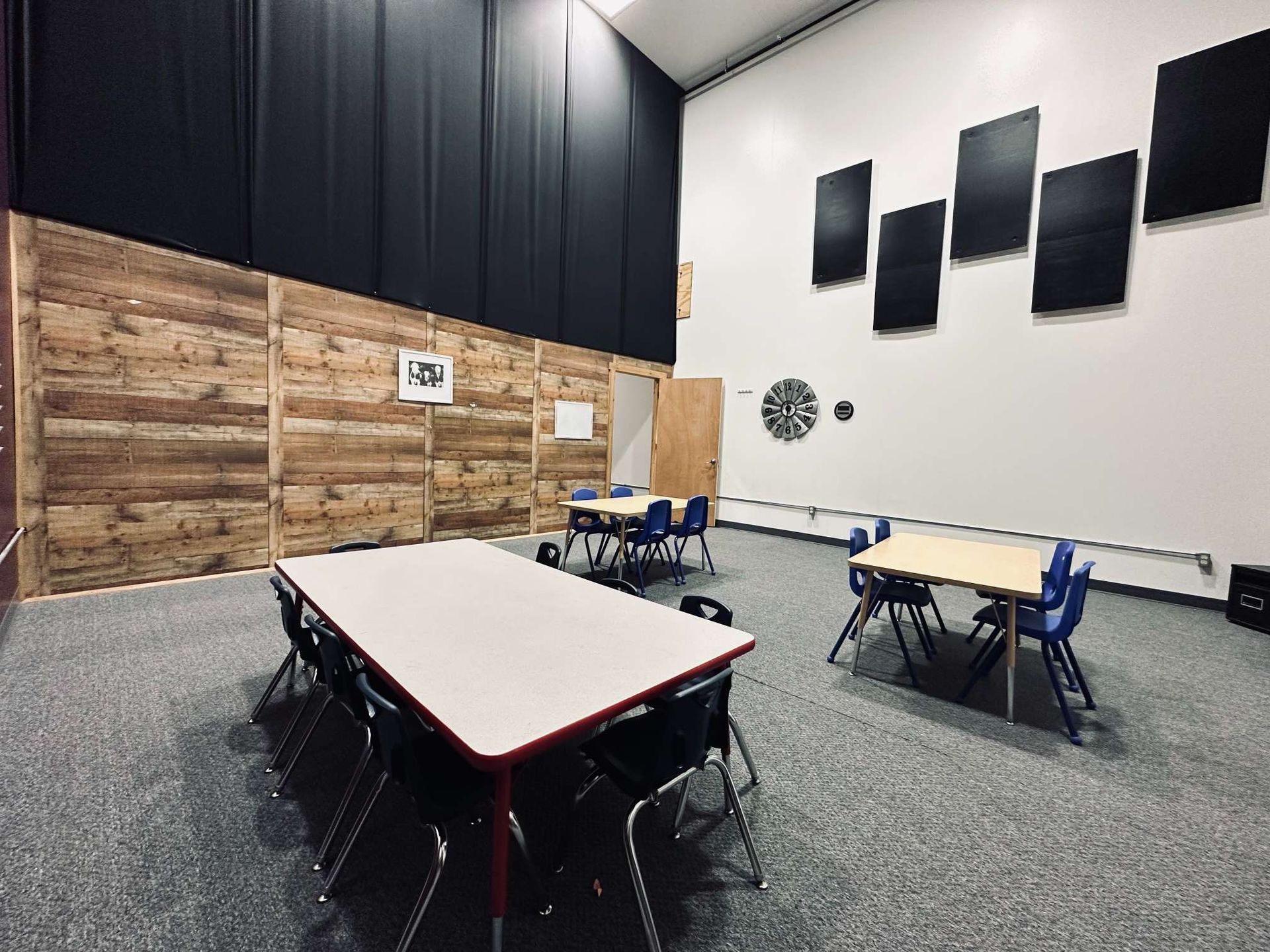 A large room with tables and chairs in it.