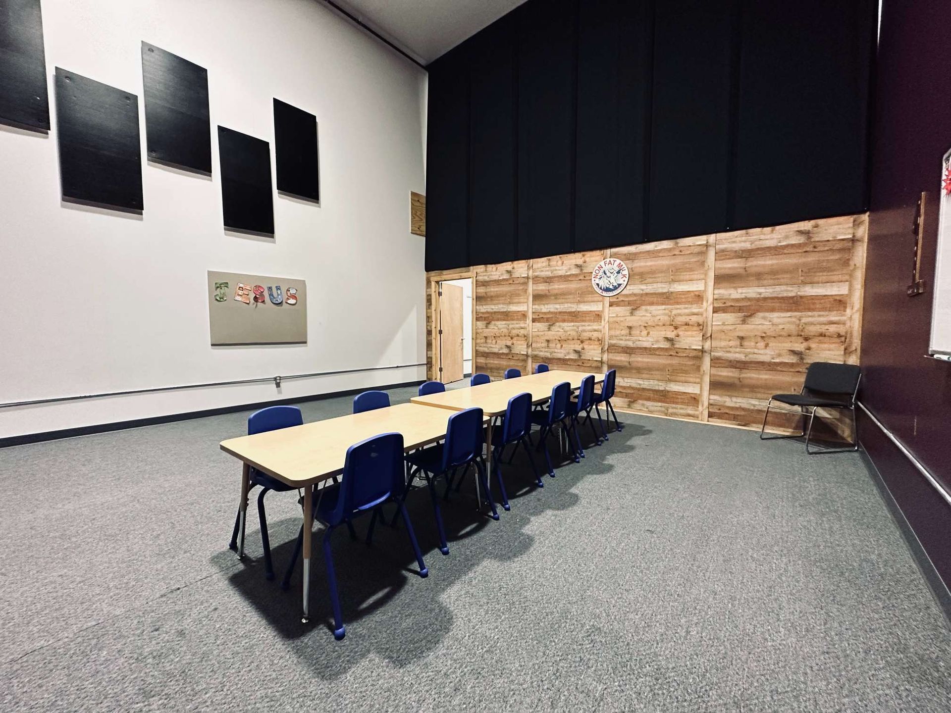 A large room with a long table and chairs in it.