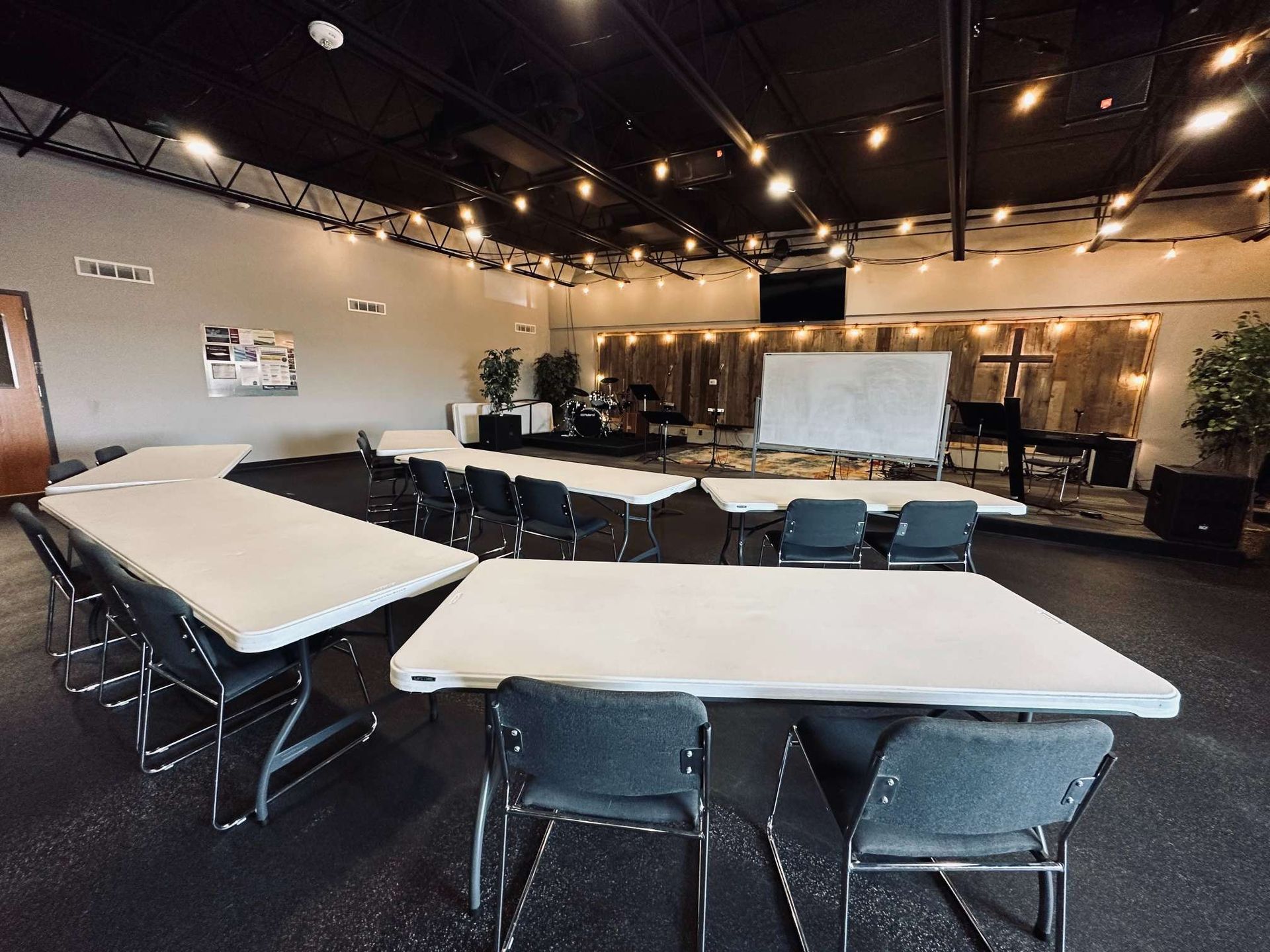 A large room with tables and chairs in it.