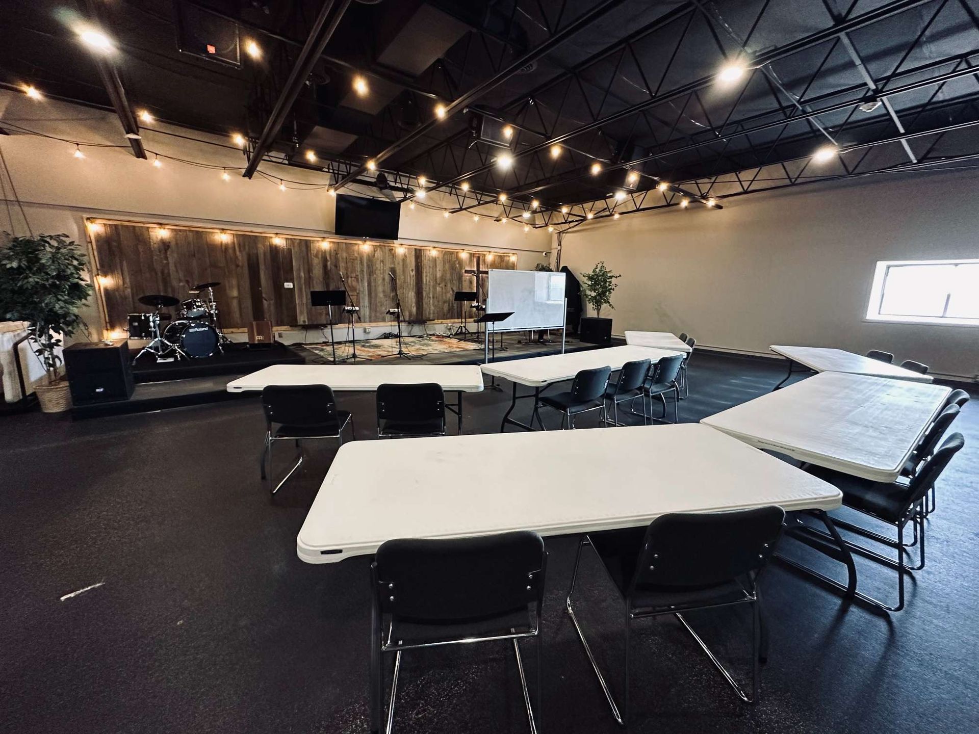 A large room with tables and chairs in it.