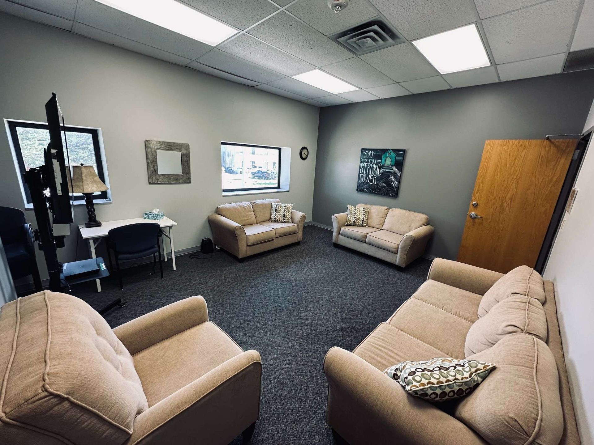 A living room with two couches and two chairs.