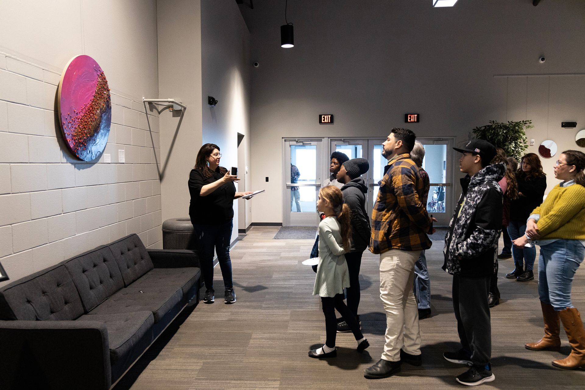A woman is talking to a group of people in a living room.