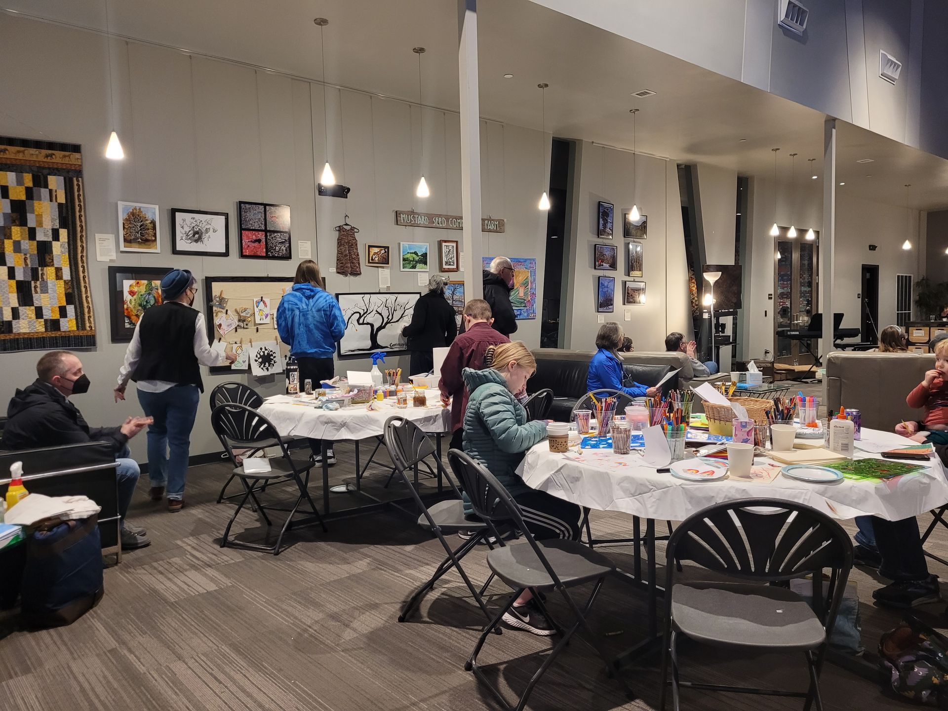 A group of people are sitting at tables in a room.