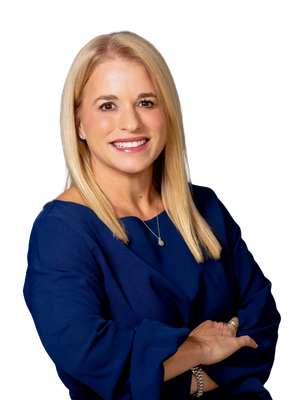 Marie Frances smiles, wearing a white blazer and necklace, posing against a white background.