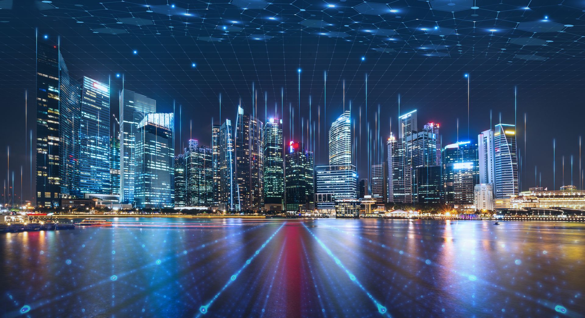 City skyline at night with digital network lines overlayed, connecting buildings.