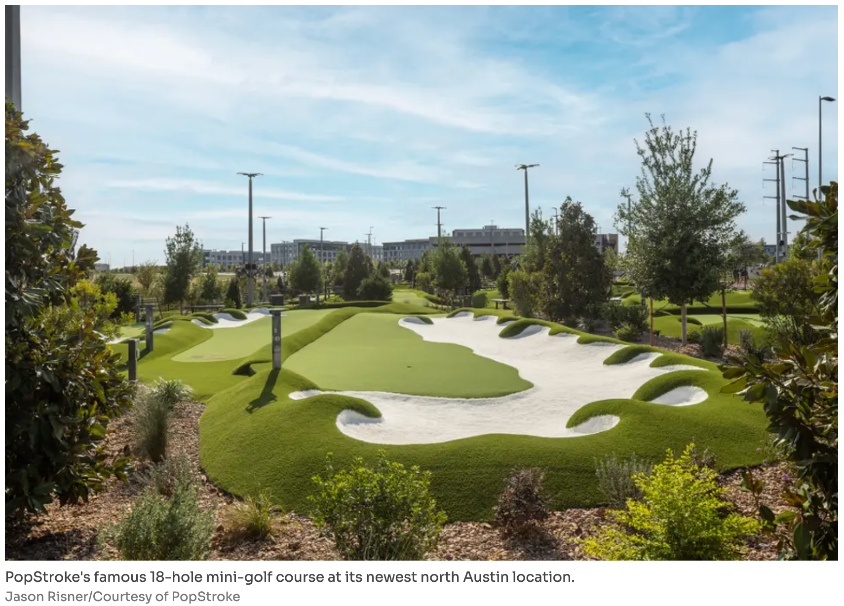 A vibrant green 18-hole mini-golf course with sand traps and trees at an outdoor location in North Austin.