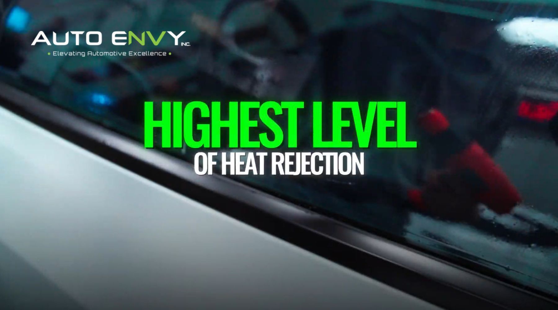 Technician applying window tint film to a vehicle side window at Auto Envy