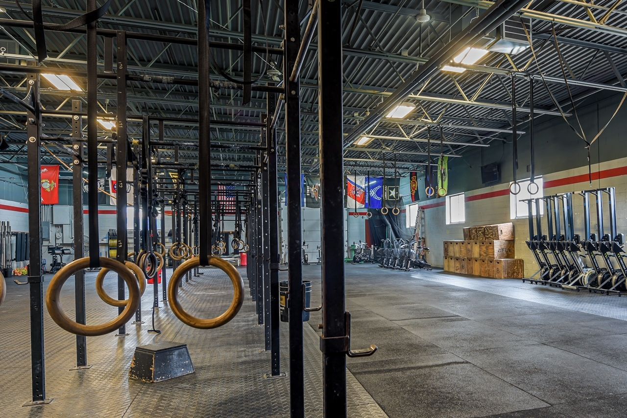 A gym with a lot of rings hanging from the ceiling.