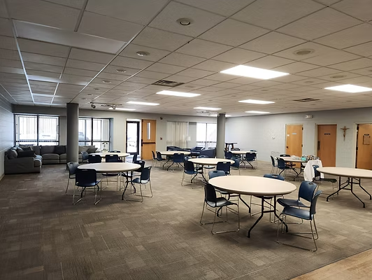 A large room with tables and chairs in it