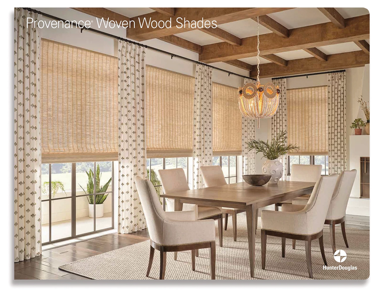 Dining room featuring Provenance woven wood shades on floor-to-ceiling windows, patterned curtains, and neutral furniture.