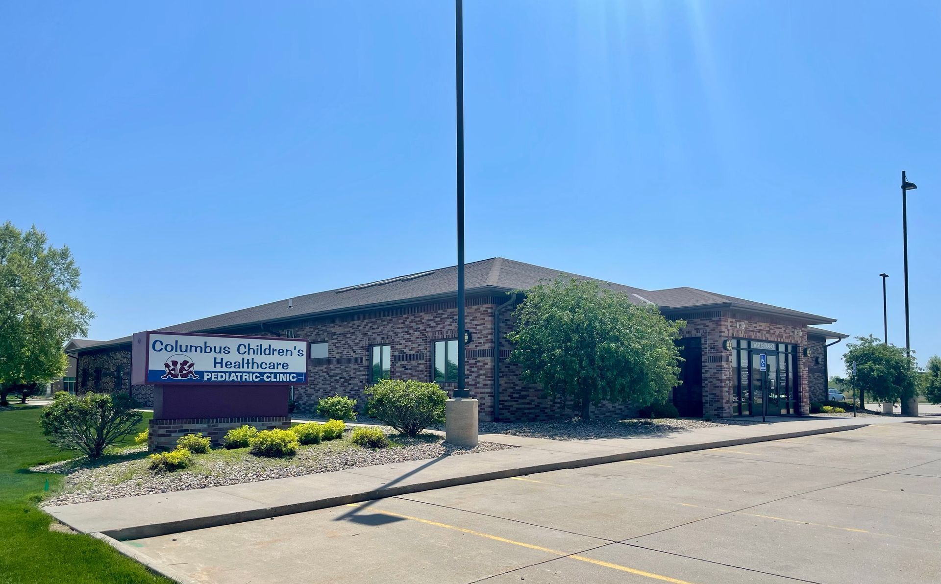 A large brick building with a sign in front of it.