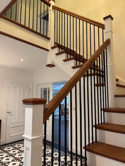 Cut string staircase walnut tread and handrail with metal spindles
