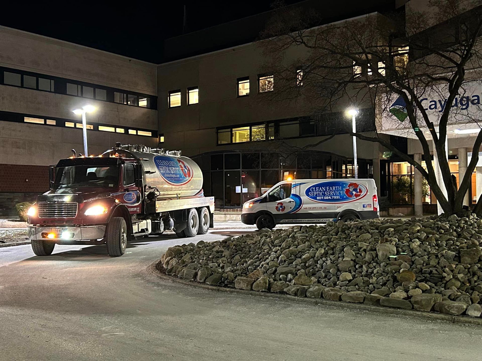 septic pump truck and service van at commercial building