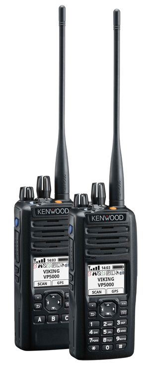 A row of walkie talkies sitting on top of a table.