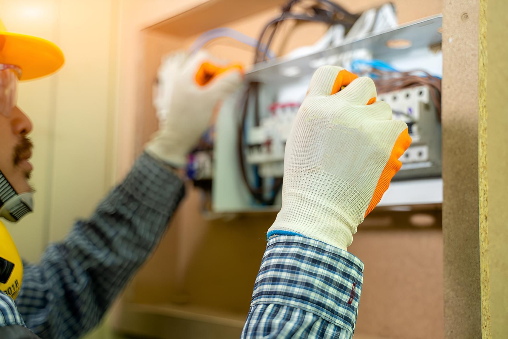 Man Wearing Gloves — Robbie McDonald Electrical in Mooloolaba, QLD