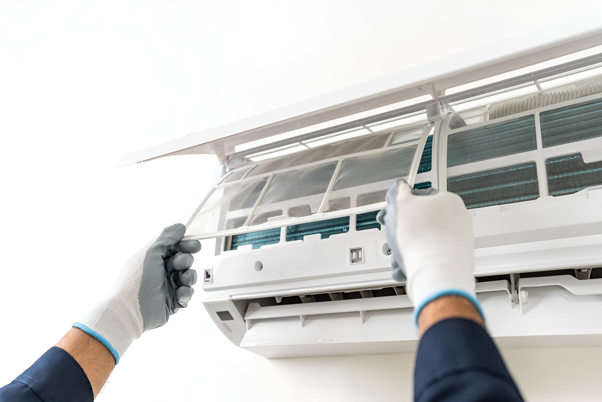 Person is Cleaning an Air Conditioner — Robbie McDonald Electrical in Yandina, QLD