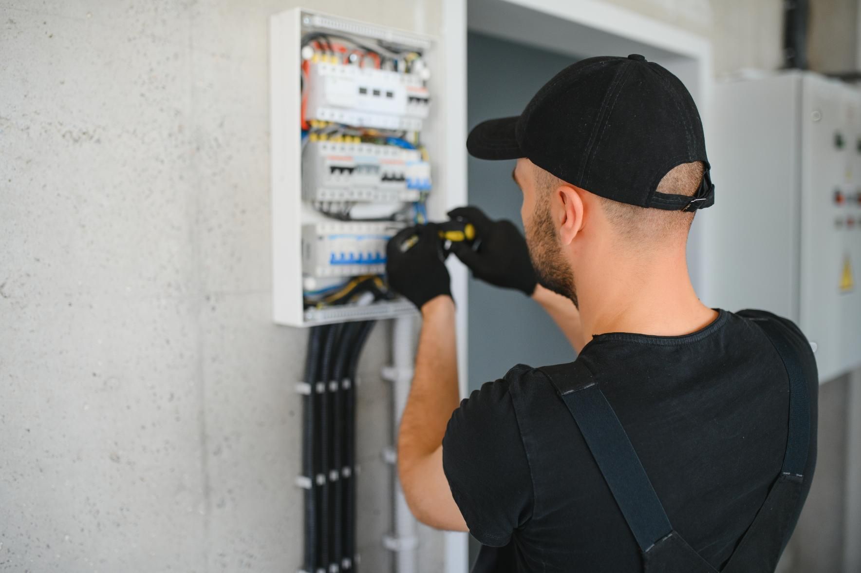 Man is Working on an Electrical Box — Robbie McDonald Electrical in Caloundra, QLD