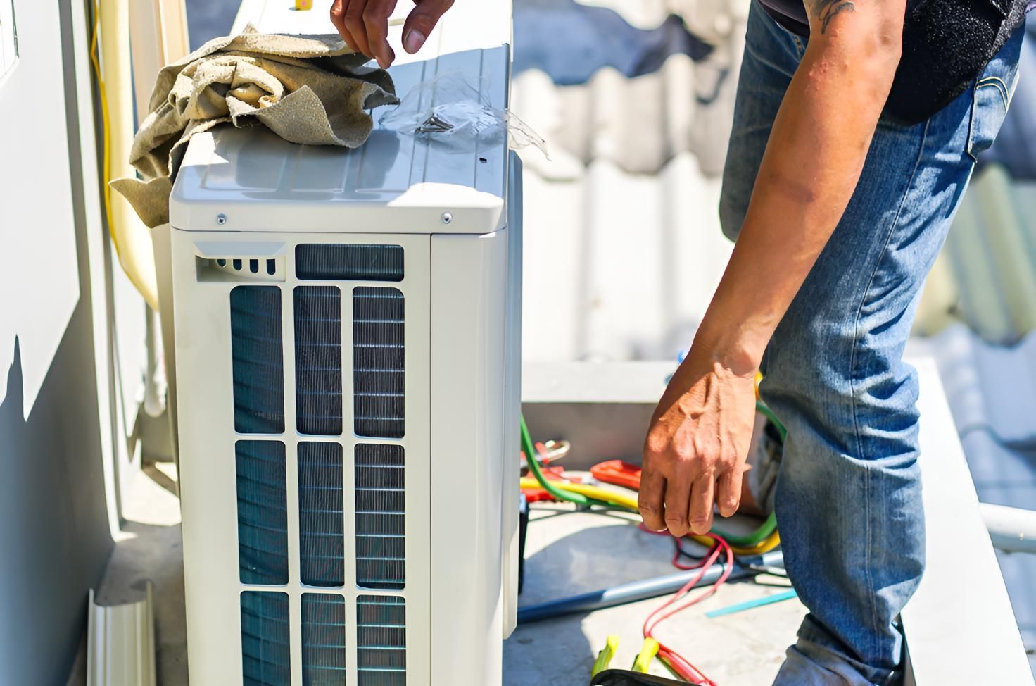 Man is Working on an Air Conditioner — Robbie McDonald Electrical in Golden Beach, QLD