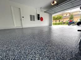 A glossy, newly installed flake-style epoxy floor in a residential garage.