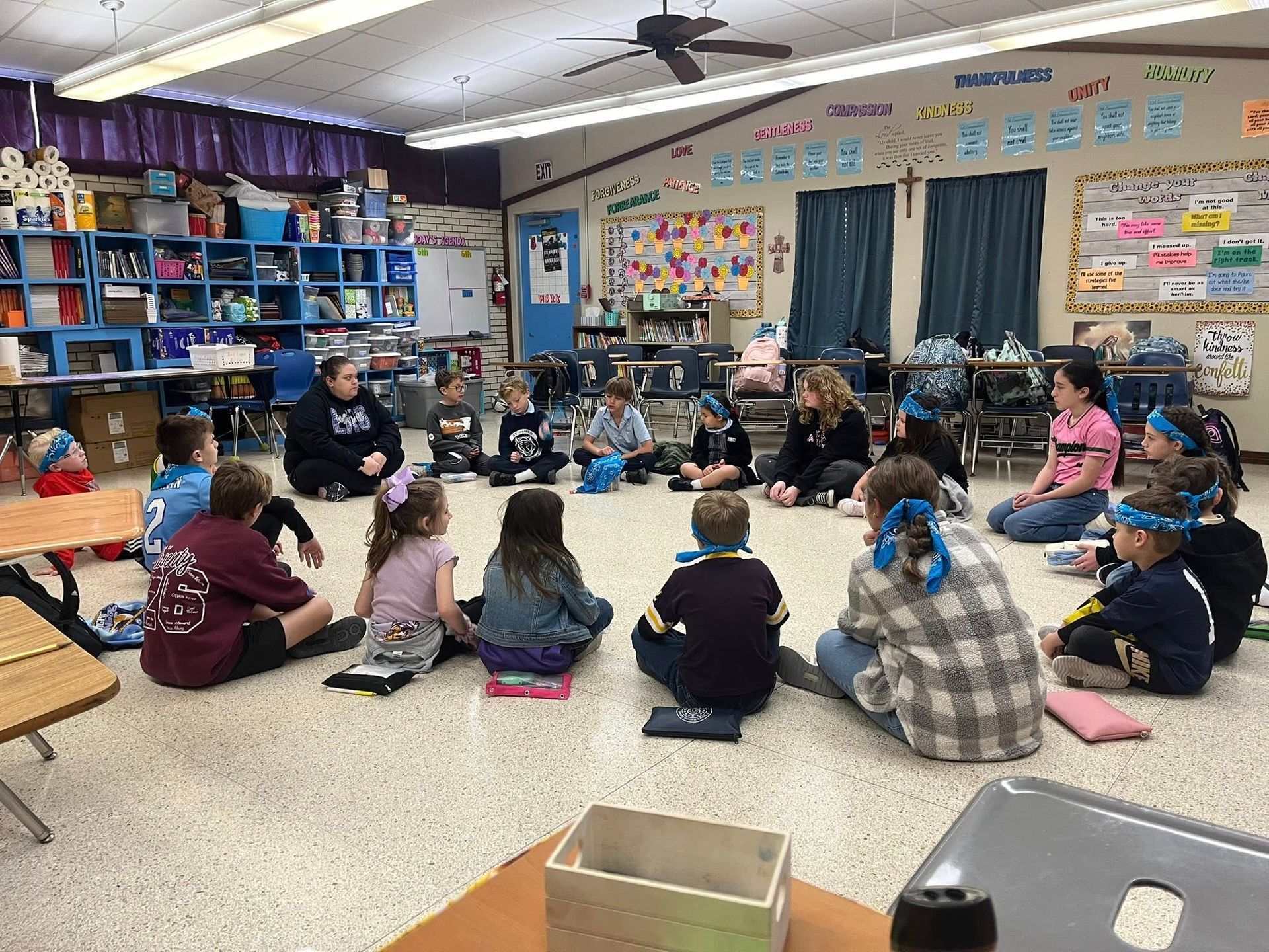 A group of students are sitting at desks in a classroom