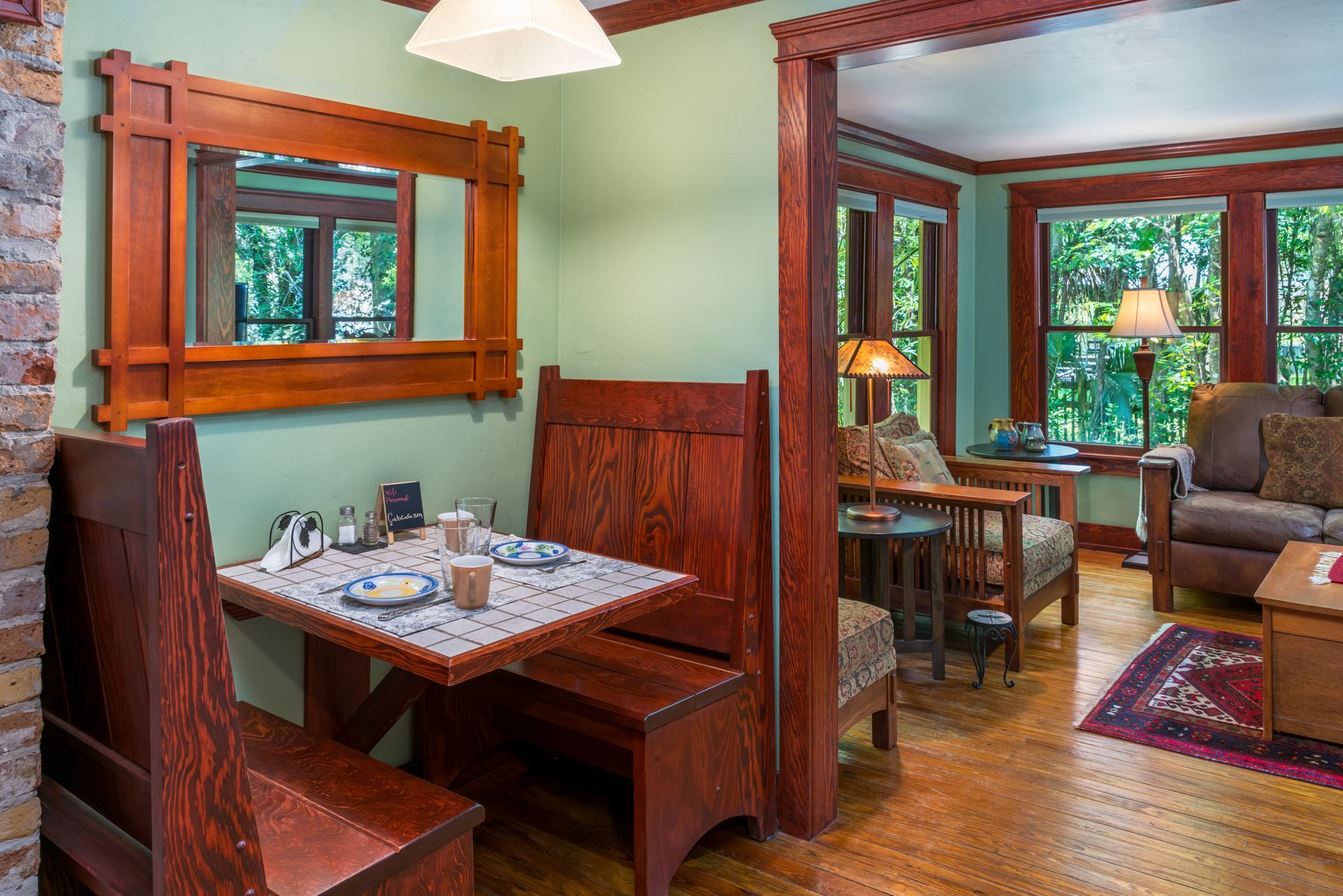 a kitchen with a table and benches and a refrigerator