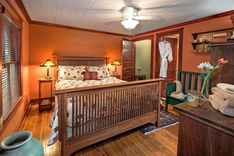a bedroom with a king size bed and a ceiling fan .