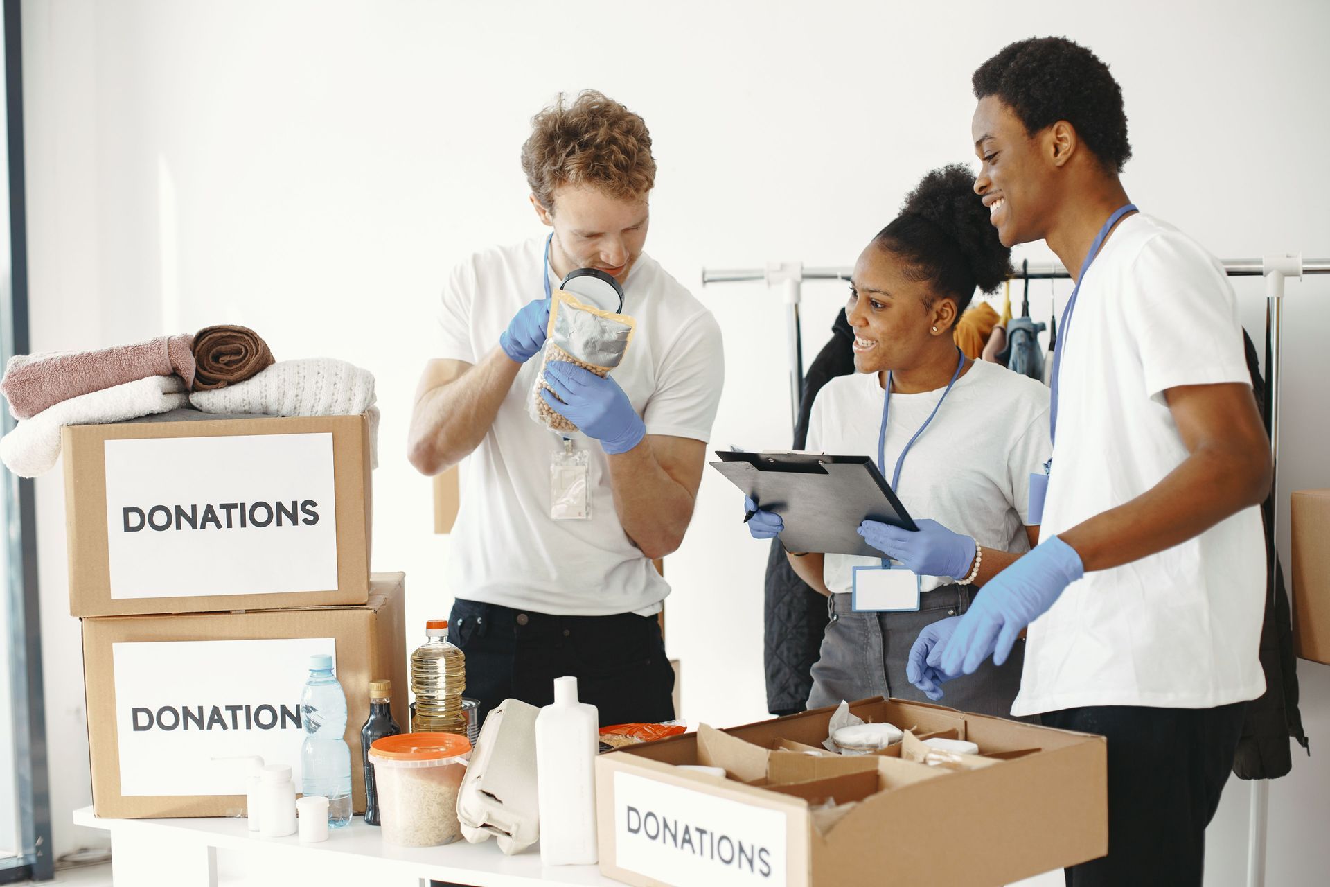 Volunteers sorting donated food and supplies in a donation center