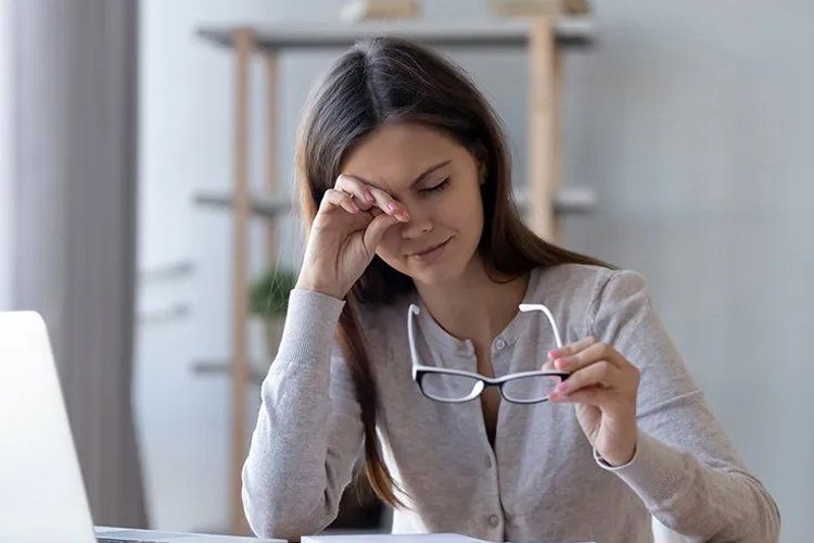 Woman scrubbing her eyes Woman scrubbing her eyes