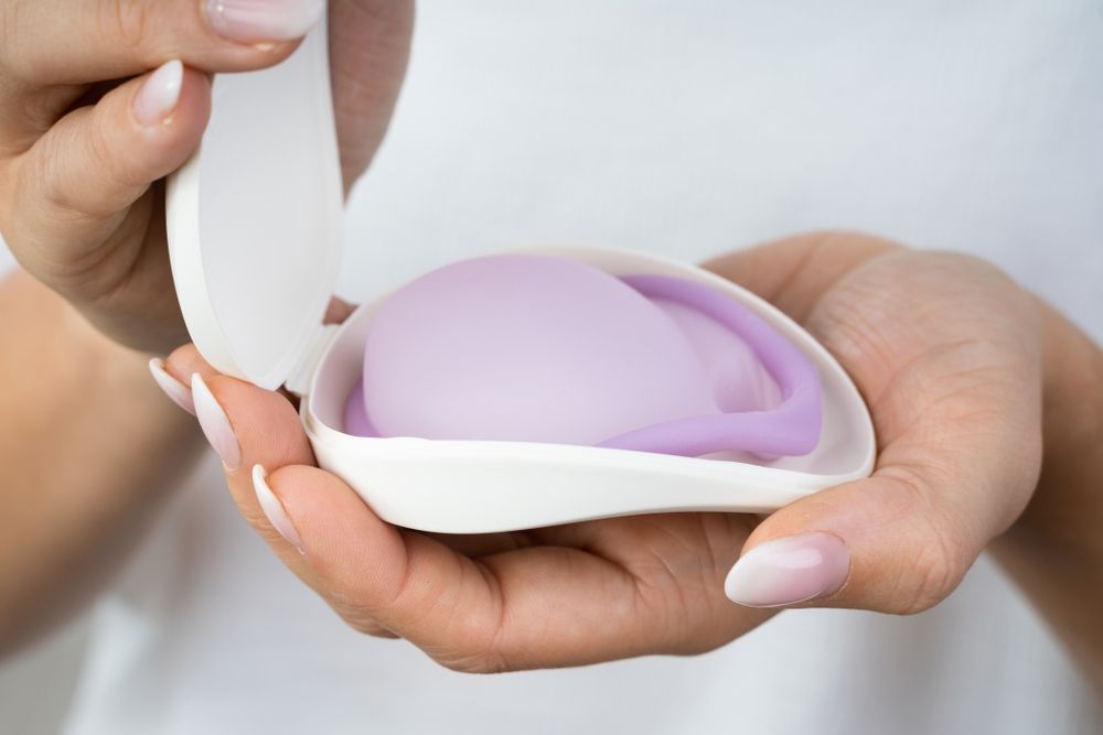 A Woman is Holding a Purple Device in Her Hands — One Stop Medical in Mackay, QLD