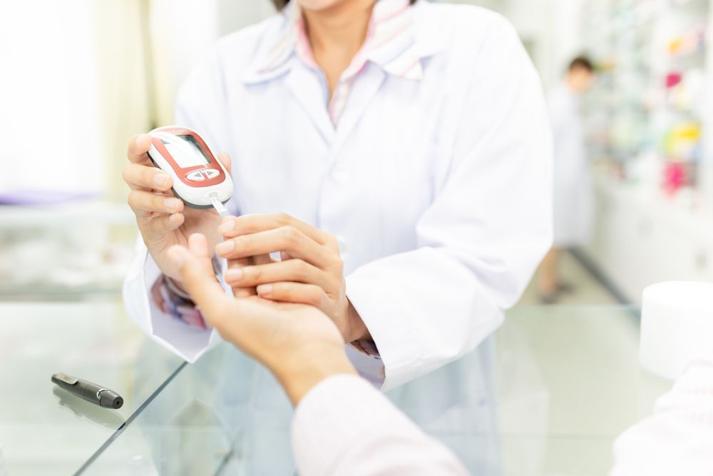 Doctor Checking a Patient’s Blood Sugar With a Glucose Meter — One Stop Medical in Mackay, QLD