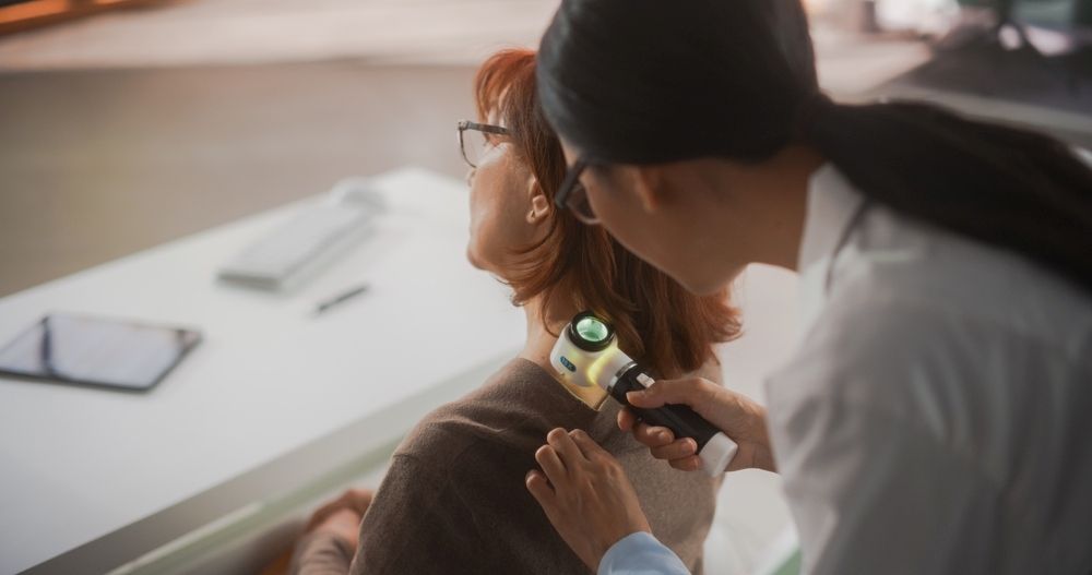 A Doctor is Examining a Woman 's Neck With a Microscope — One Stop Medical in Mackay, QLD