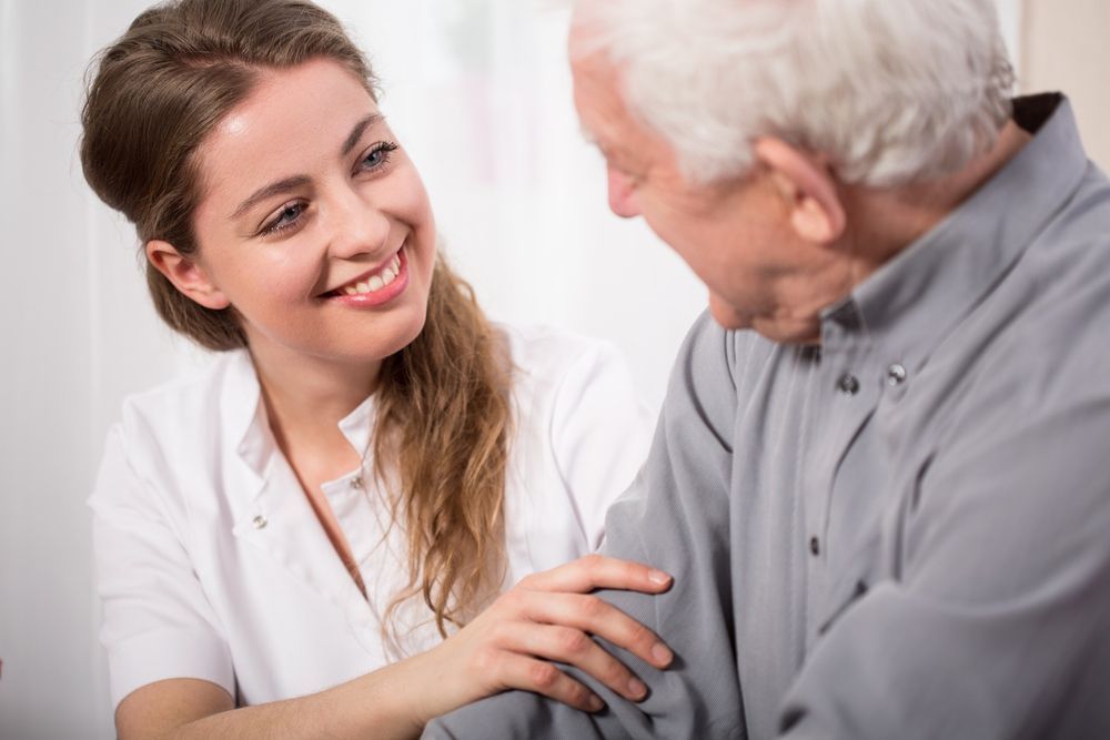 A Nurse is Holding the Arm of an Elderly Man — One Stop Medical in Mackay, QLD