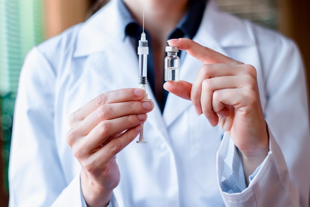 A Doctor is Holding Two Syringes in Her Hands — One Stop Medical in Mackay, QLD
