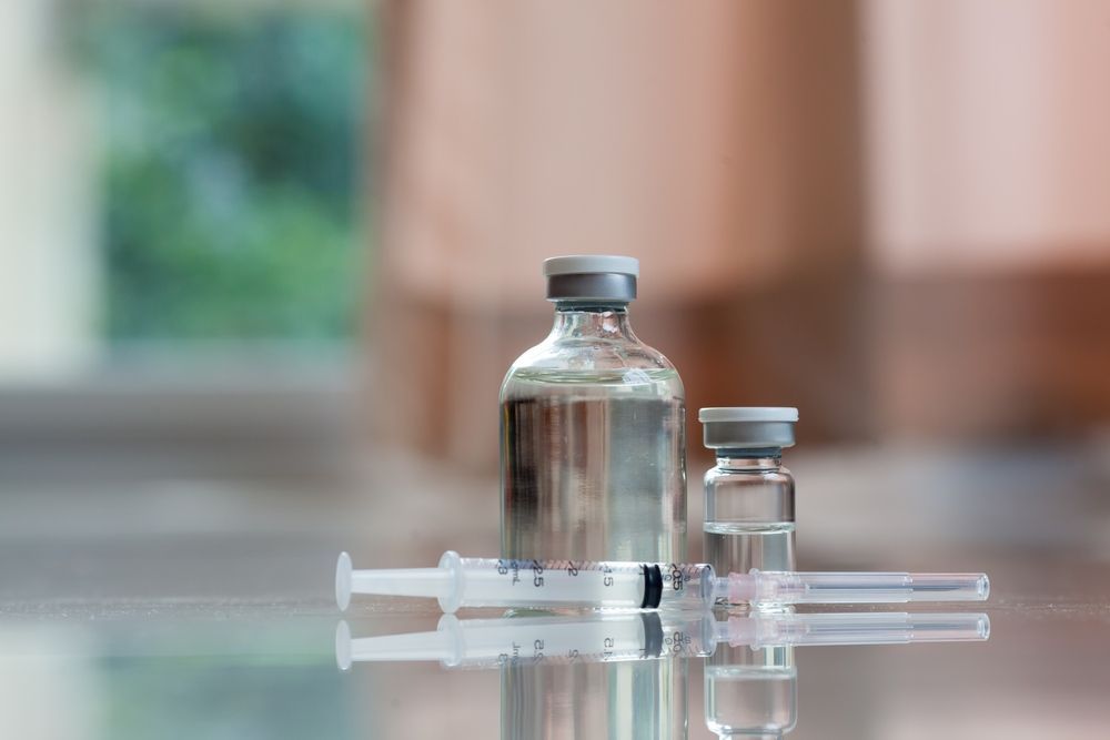 A Bottle of Liquid and a Syringe Are on a Table — One Stop Medical in Mackay, QLD
