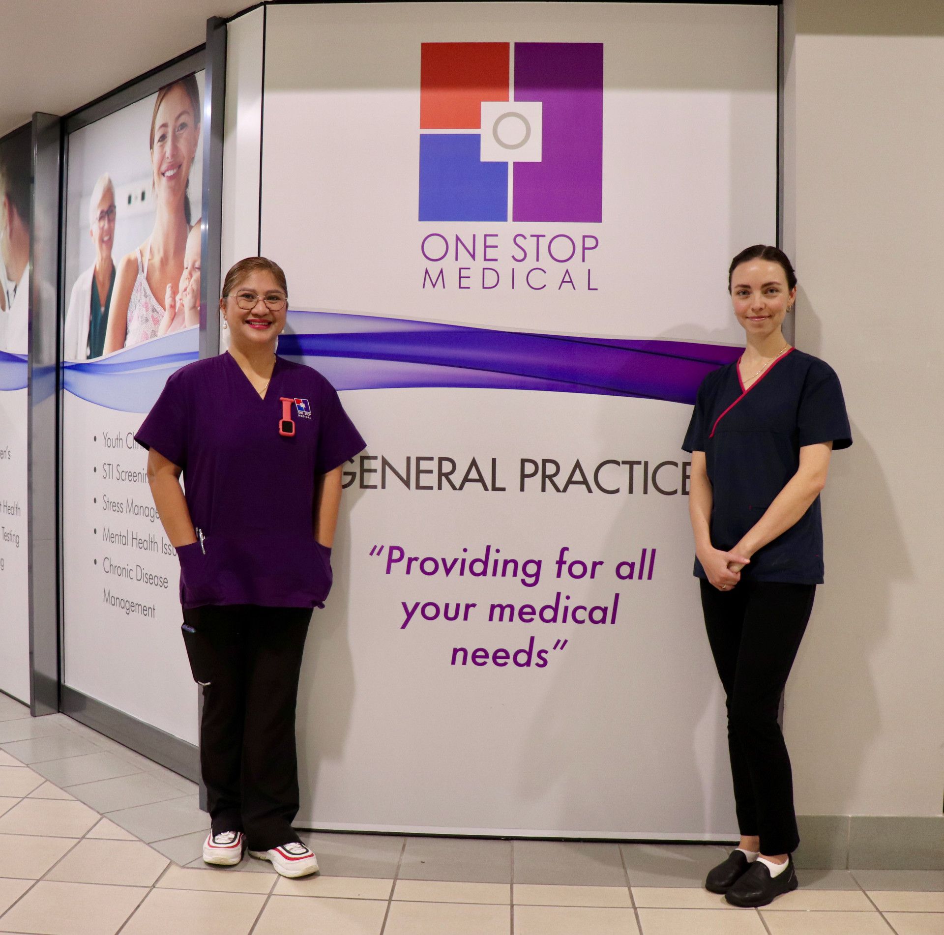 Two healthcare workers stand in front of a