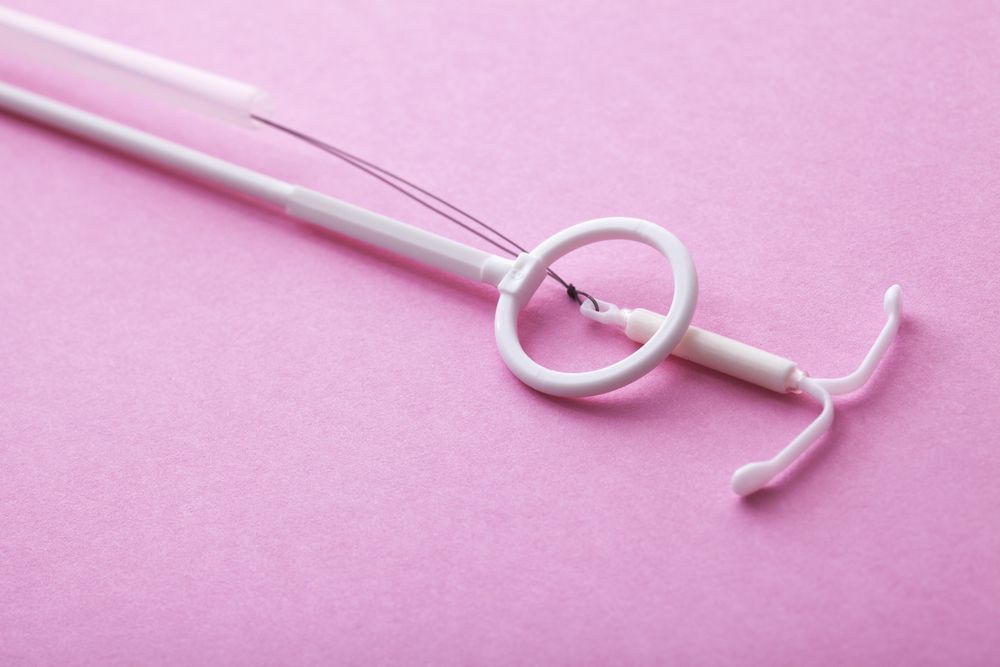 White Mirena IUD on A Pink Background — One Stop Medical in Mackay, QLD