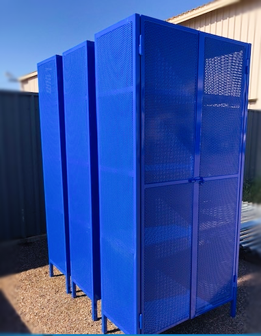 A row of blue metal lockers are sitting next to each other.