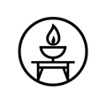 Candle flame in a bowl atop a table, enclosed in a circle.