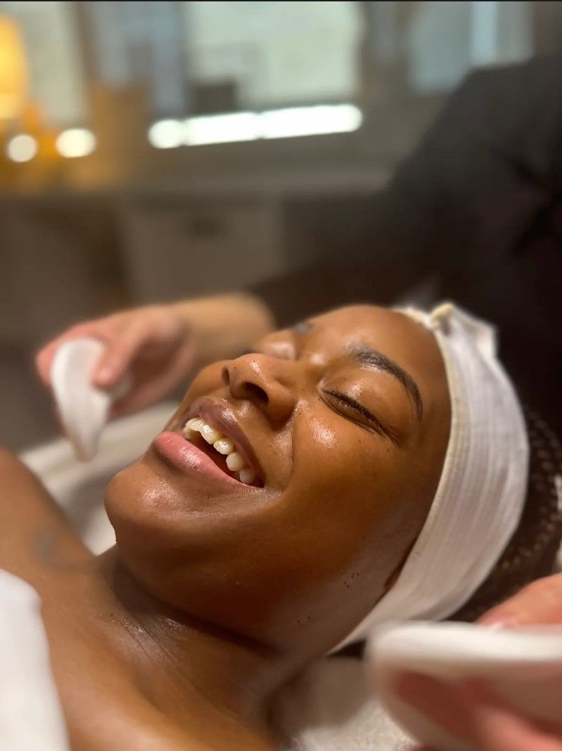 smiling woman while getting a facial