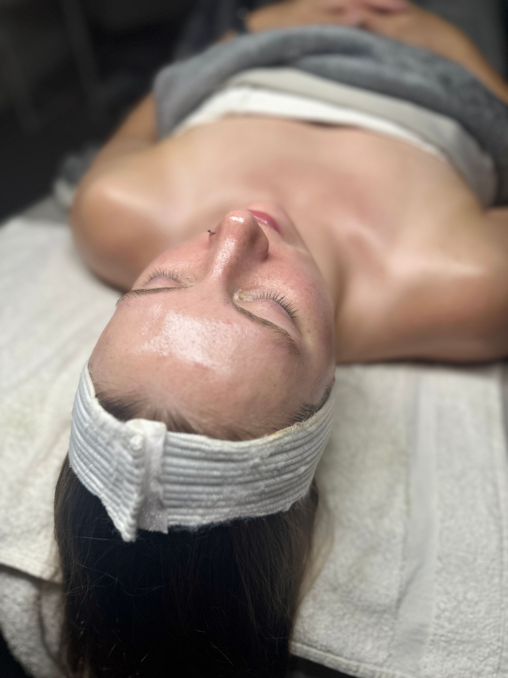 A woman is laying on a bed with a headband on her head.