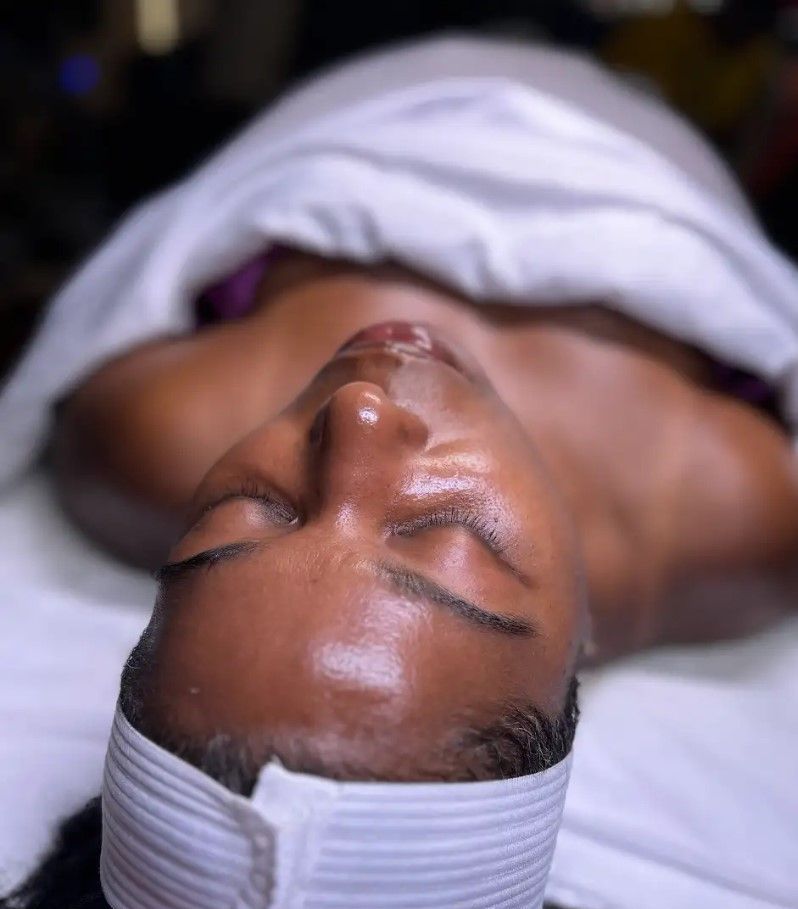 A woman is getting a facial treatment at a spa.