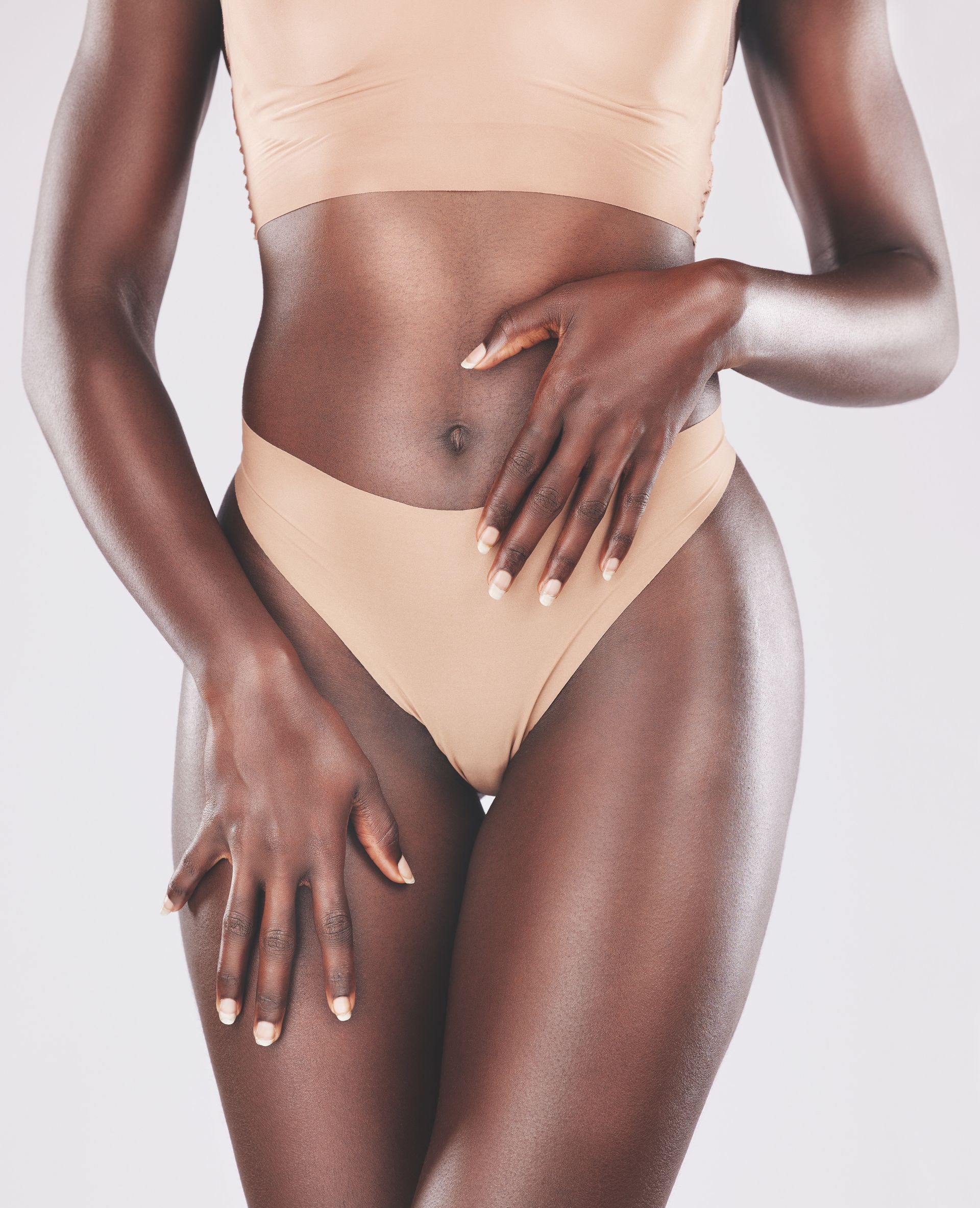 A woman with red nails is wearing black underwear