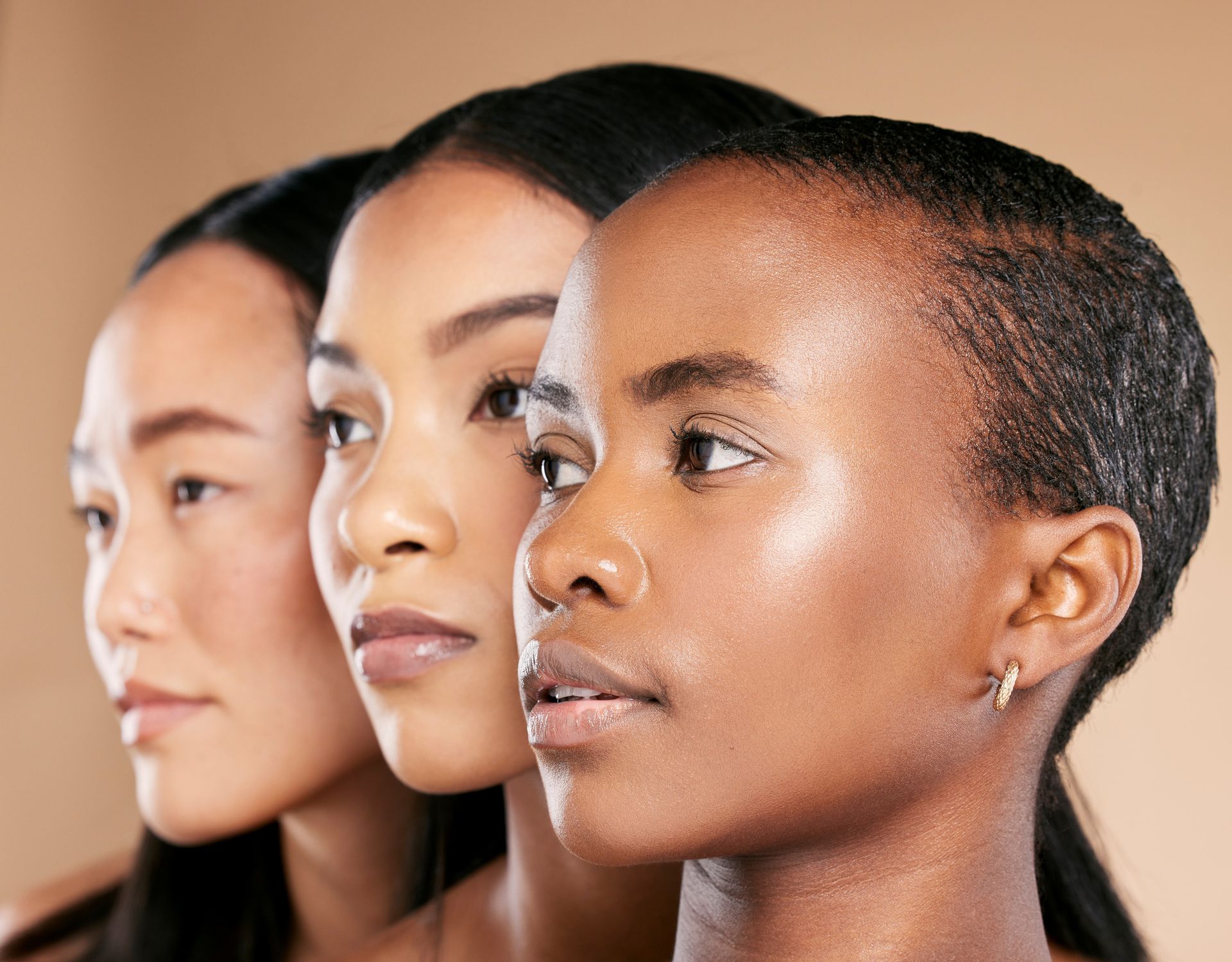 Three women in profile facing right, shown in layered close-up against a light background.