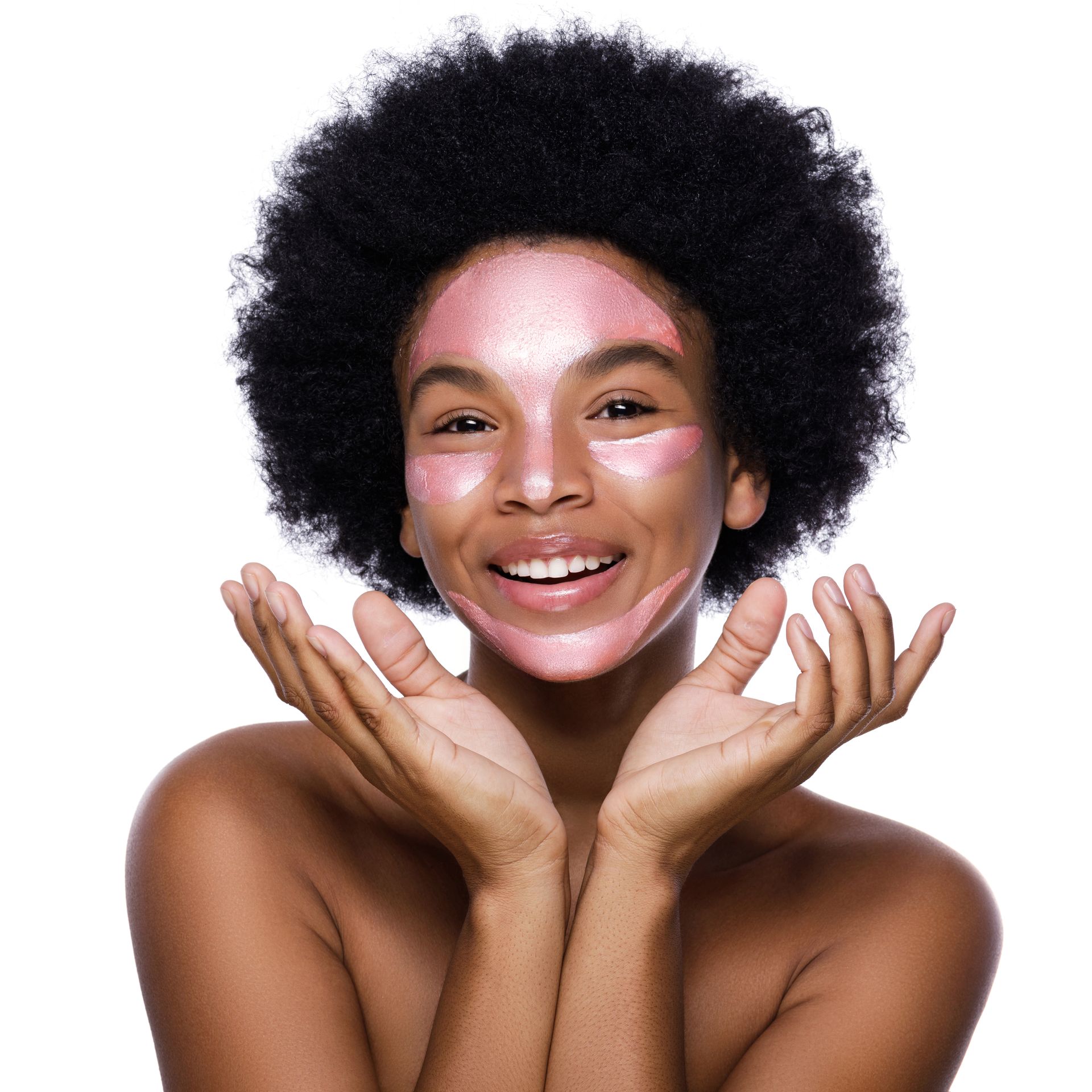 A woman with a pink mask on her face is smiling