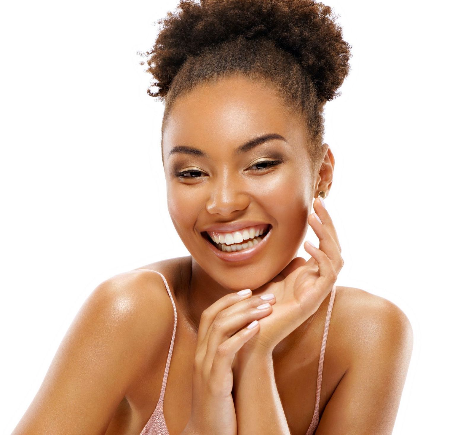 A woman is smiling and touching her face with her hands