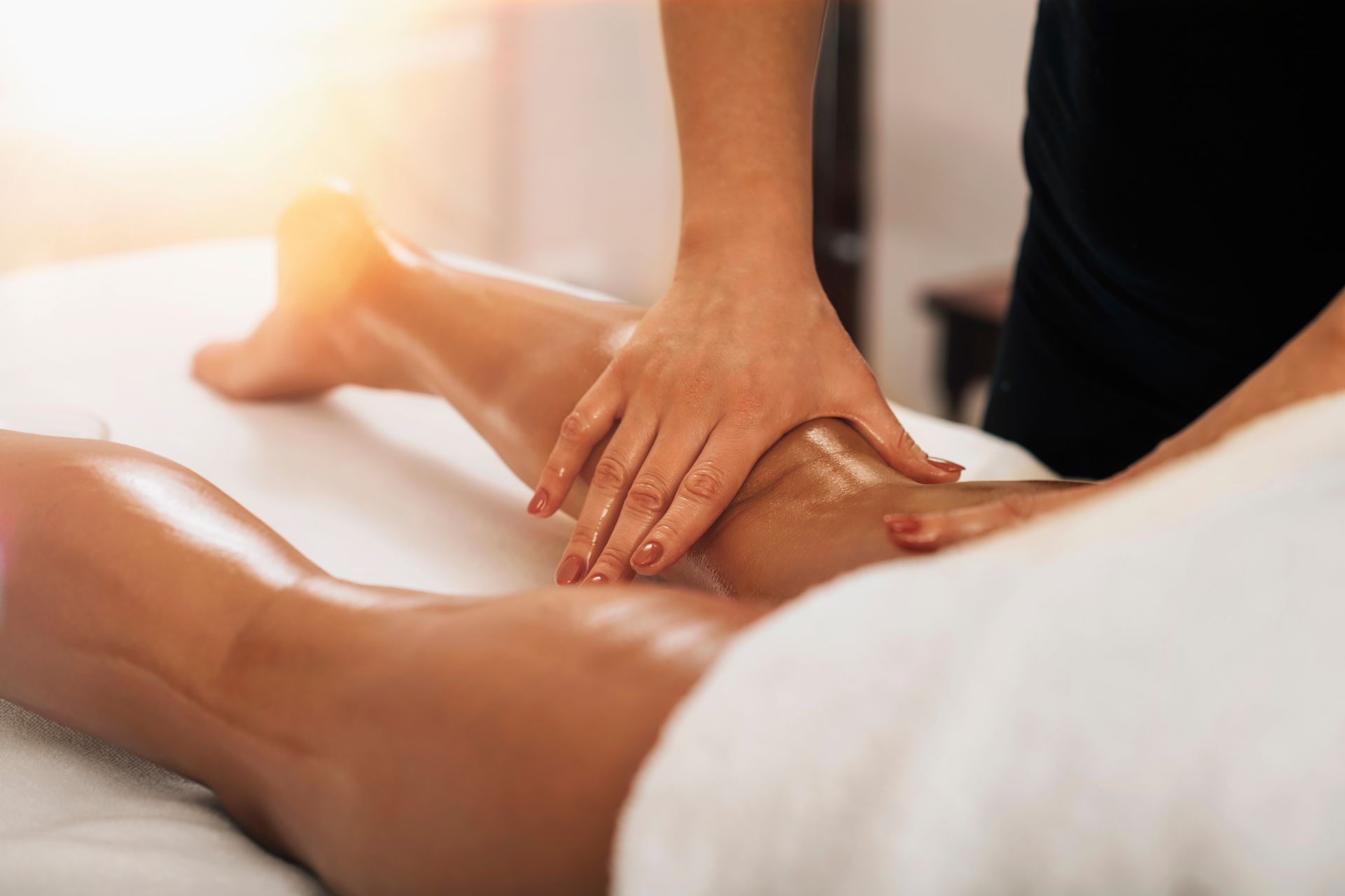 a woman is getting a massage on her leg in a spa .