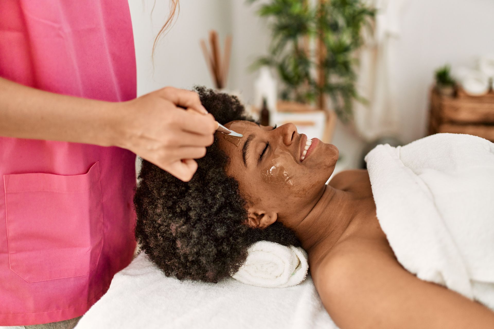 A woman is getting a facial treatment at a spa.
