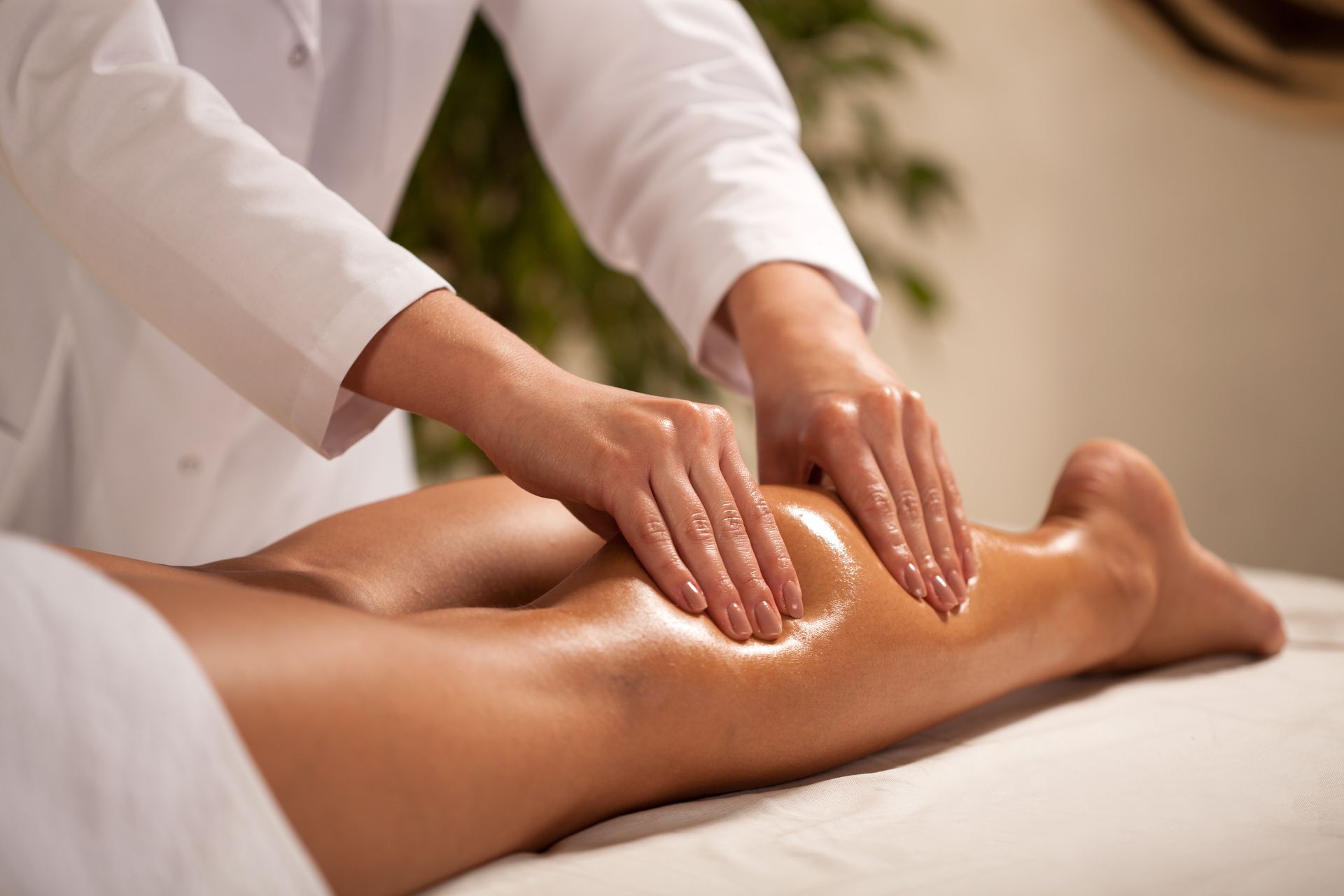 a woman is getting a massage on her leg in a spa .