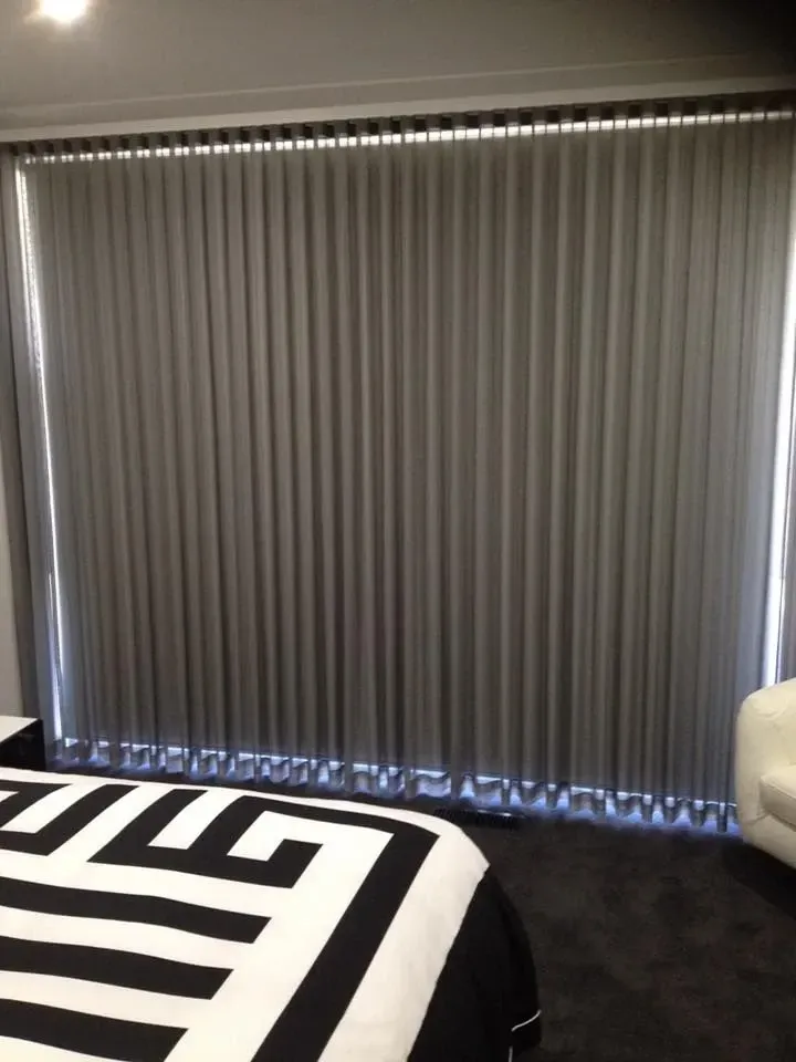 A Bedroom With Two Beds And A Large Window With Gray Curtains — Spring Crest Blinds, Awnings & Security Doors in Shepparton, VIC