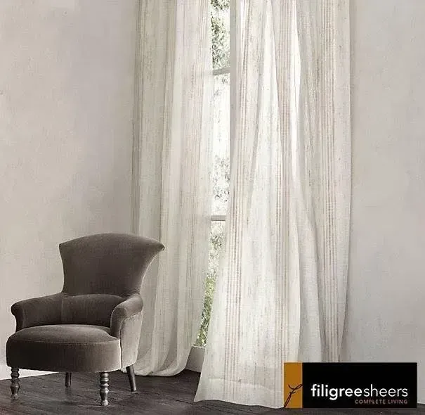A Chair Is Sitting In Front Of A Window With White Curtains — Spring Crest Blinds, Awnings & Security Doors in Golden Square, VIC